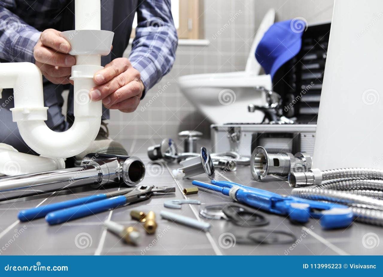 Plumber at Work in a Bathroom, Plumbing Repair Service, Assemble Stock ...
